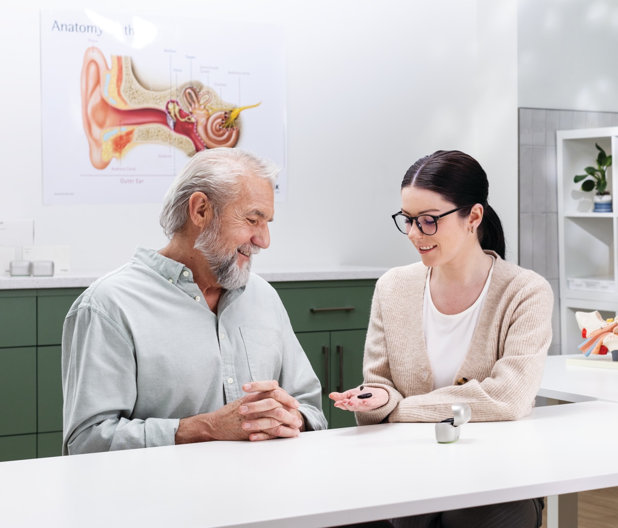 Hearing care professional explaining EasyGuard domes to patient