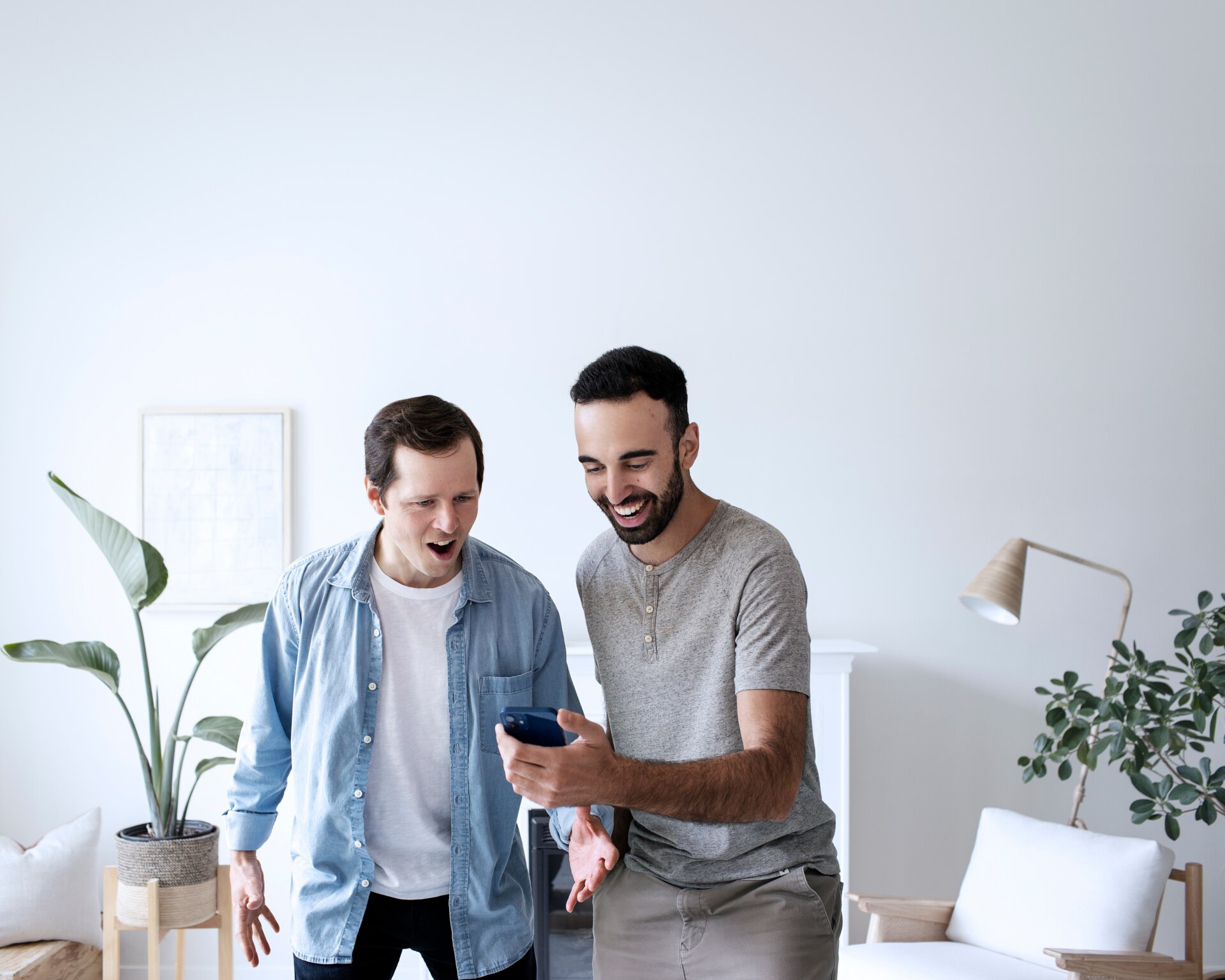 Two men looking at smartphone