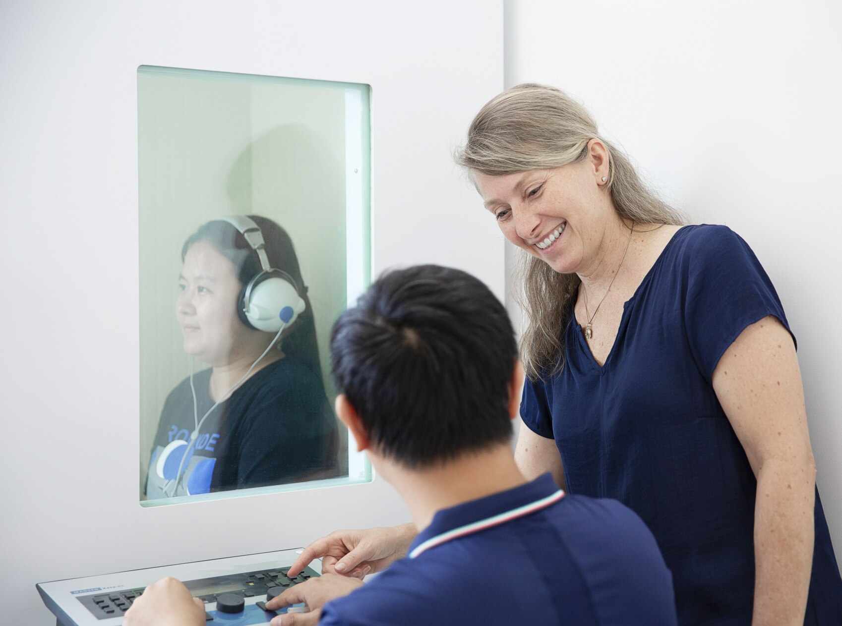 Doctor conducts examinations of ear area for woman