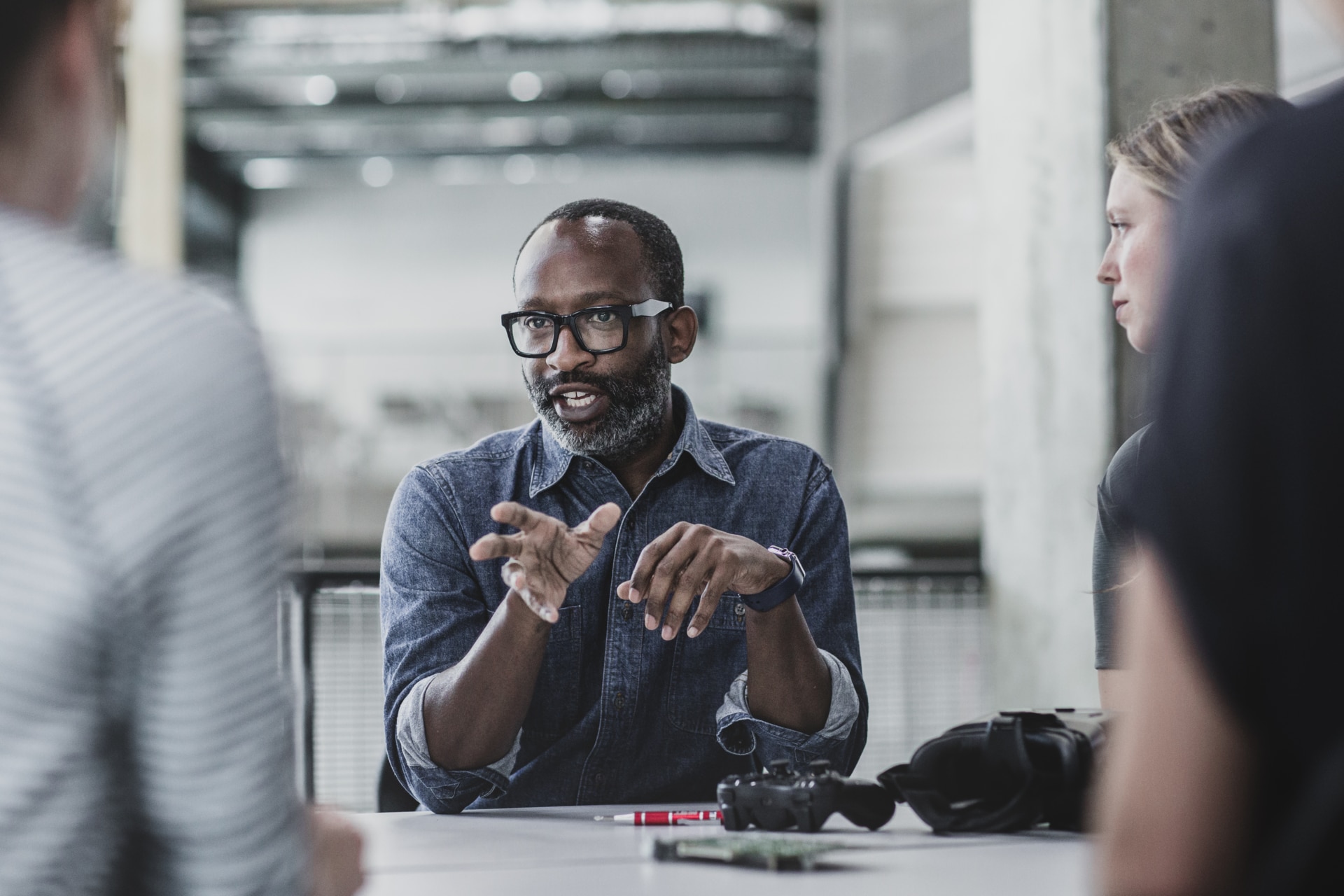 African American male game designer leading a meeting