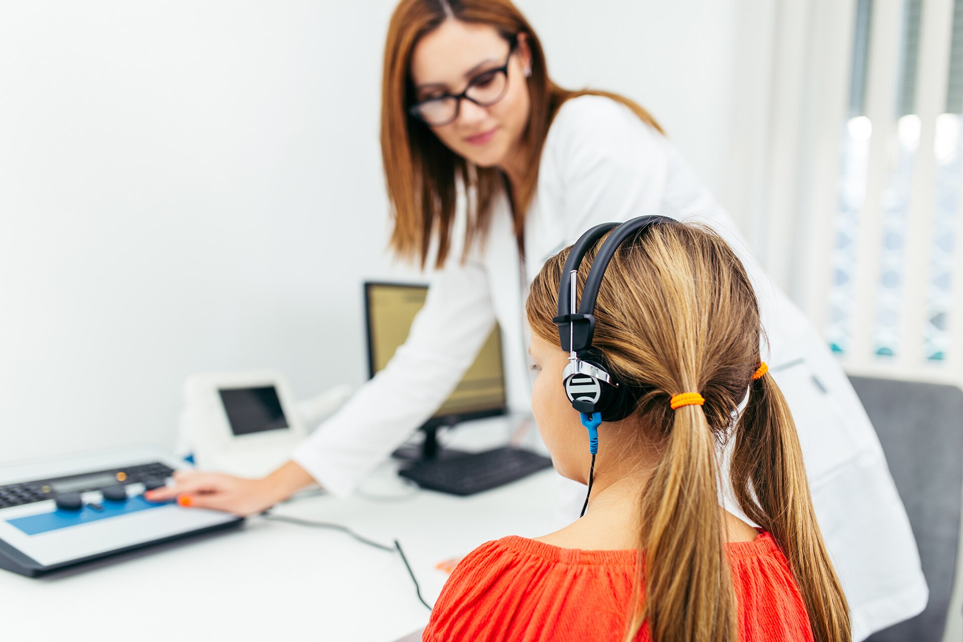 Young girl at medical examination or hearing aid checkup in otolaryngologist's office; Shutterstock ID 1201417399; purchase_order: -; job: -; client: -; other: -