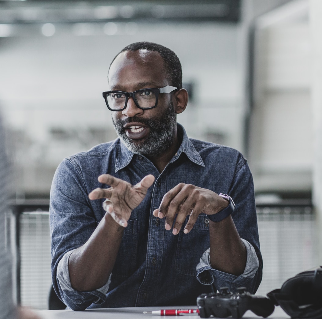 African American male game designer leading a meeting