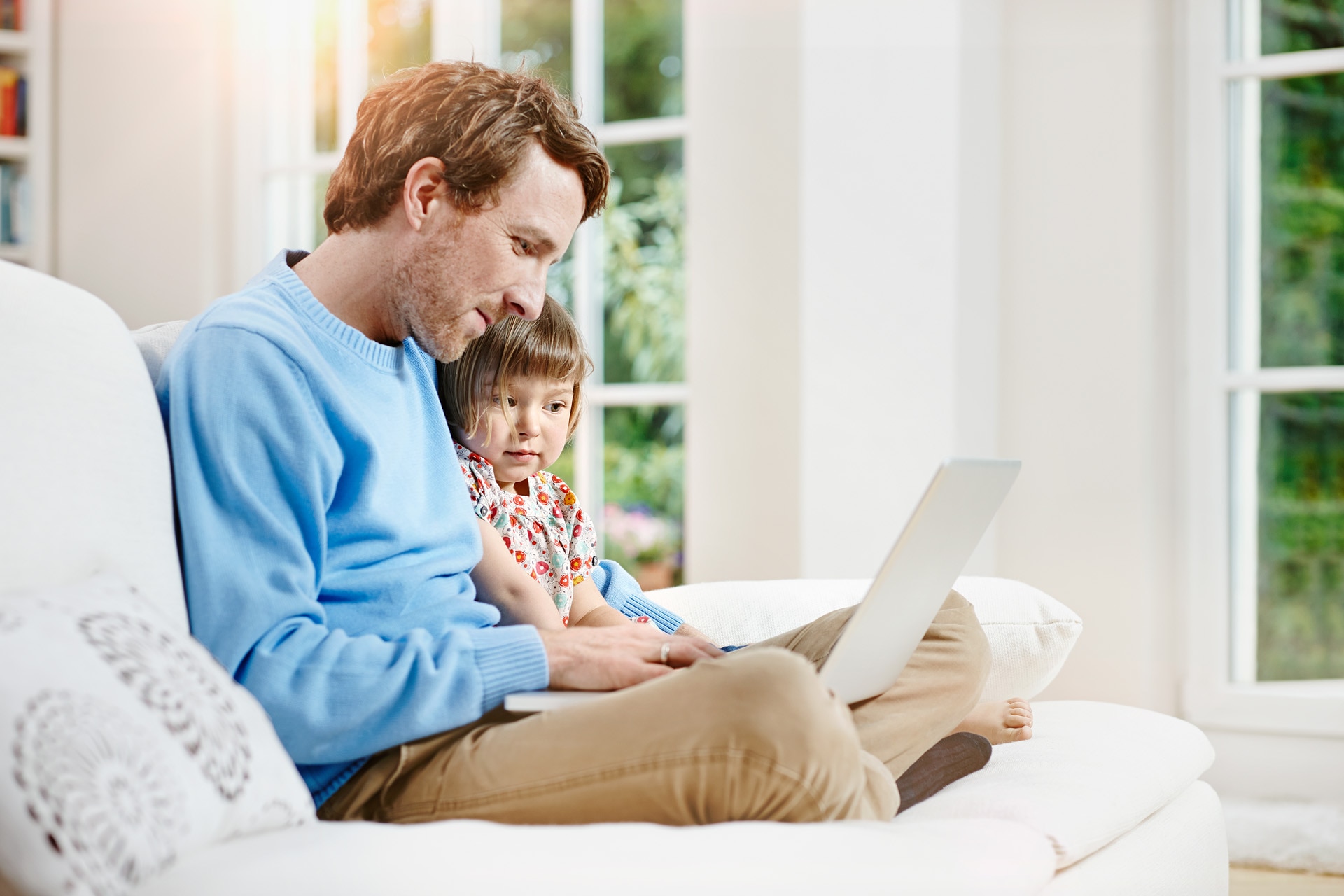 Father and daughter using laptop