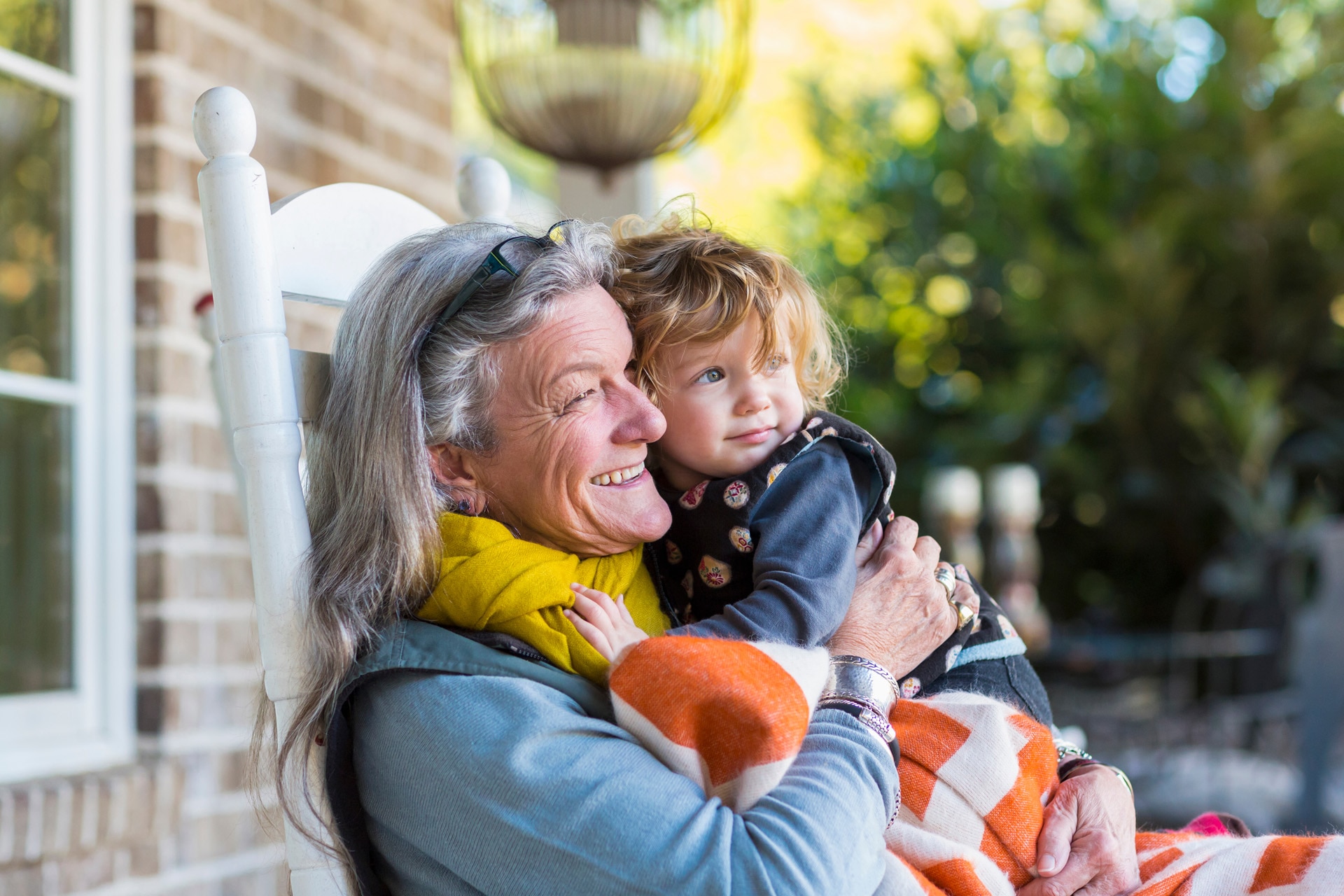 Grandmother and grandson sitting on porch.