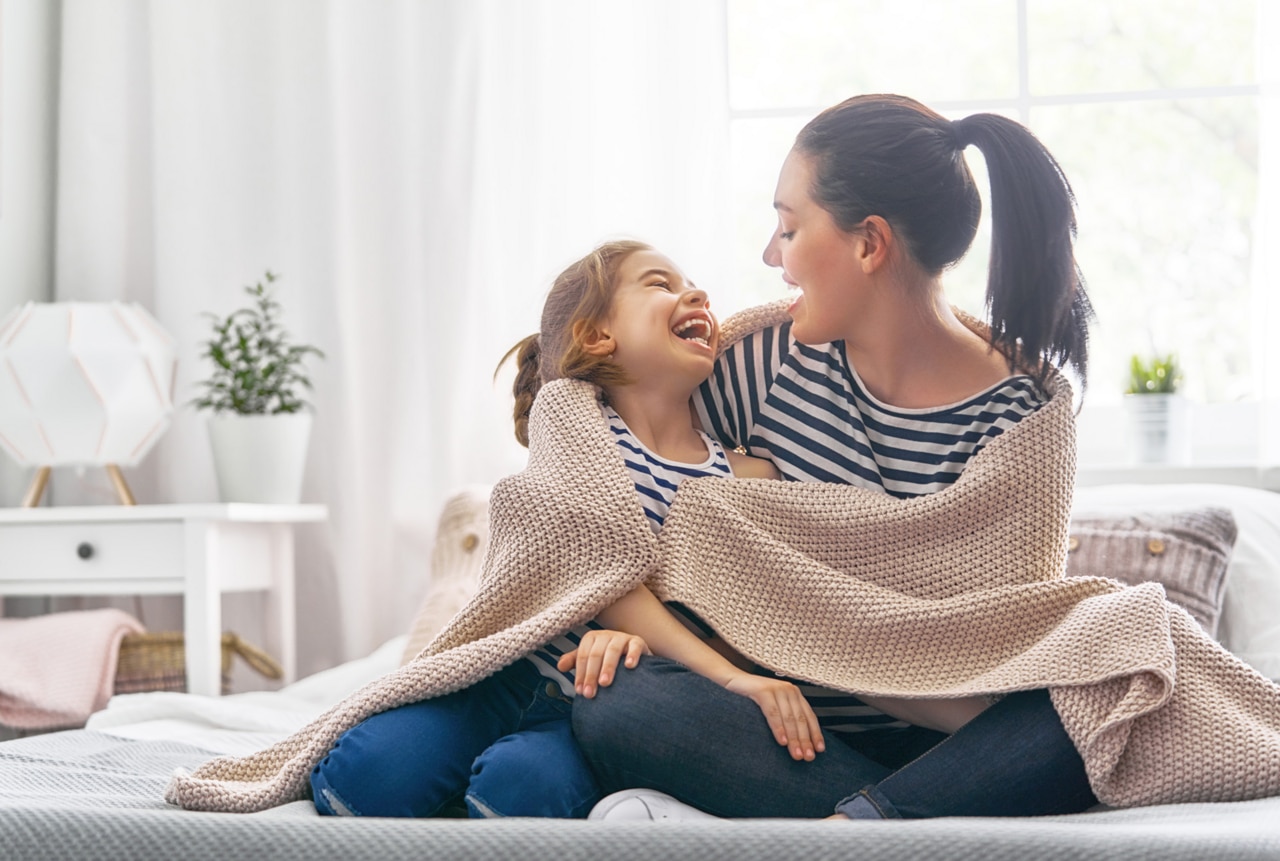 A nice girl and her mother enjoy sunny morning. Good time at home