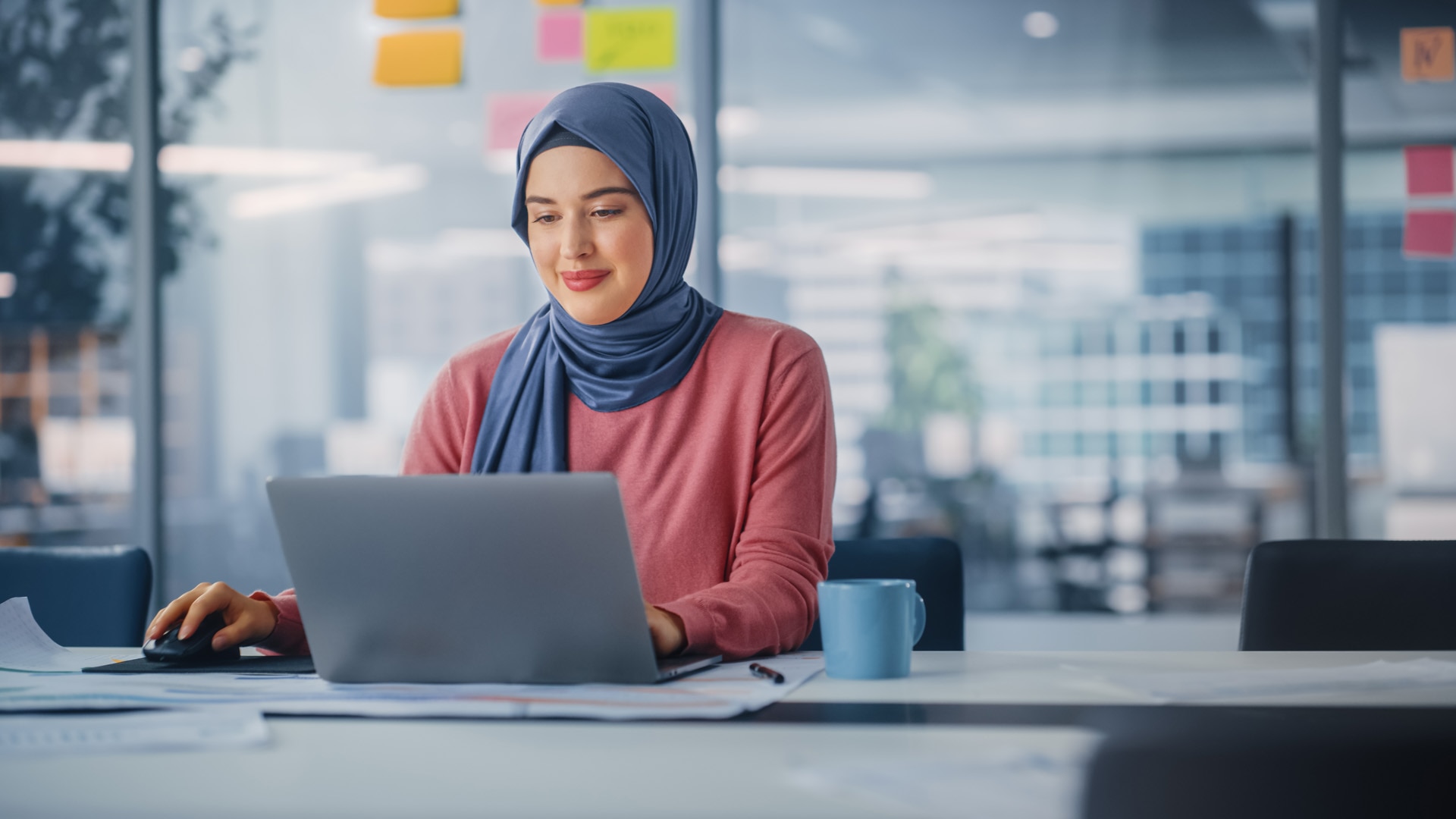 Modern Office: Portrait of Young Muslim Businesswoman Wearing Hijab Works on Laptop, Does Data Analysis, Website Design, Creative Development. Digital Entrepreneur Works on e-Commerce Startup Project; Shutterstock ID 2101929397; purchase_order: -; job: -; client: -; other: -