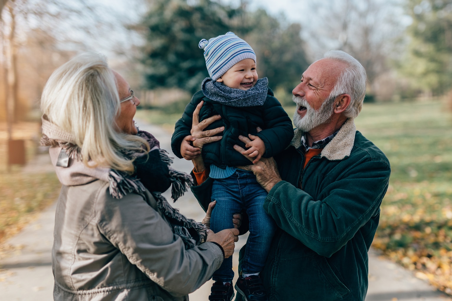 Happy good looking senior couple husband and wife walking and playing with their adorable grandson in public city park; Shutterstock ID 1846904110; purchase_order: -; job: -; client: -; other: -