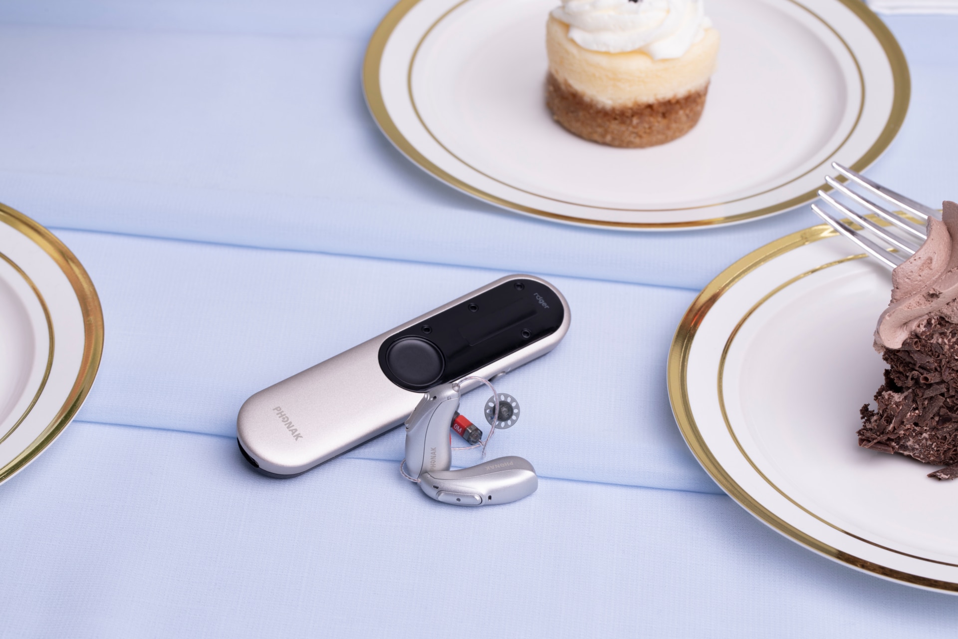 Phonak Audéo L-R hearing aid with Roger On microphone on a coffee table