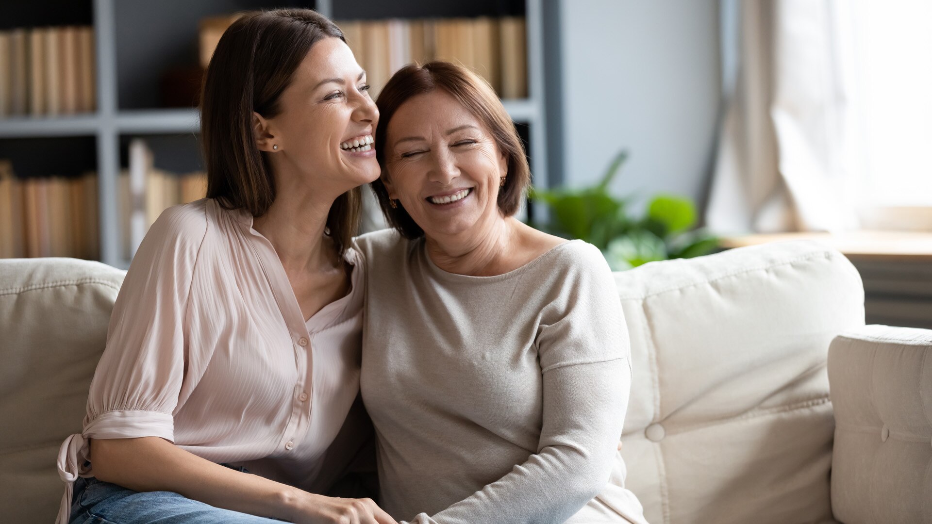 Happy senior mother and grownup daughter sit relax on couch in living room talk laugh and joke, smiling overjoyed middle-aged mom and adult girl child rest at home have fun enjoying weekend together; Shutterstock ID 1613073085; purchase_order: -; job: -; client: -; other: -