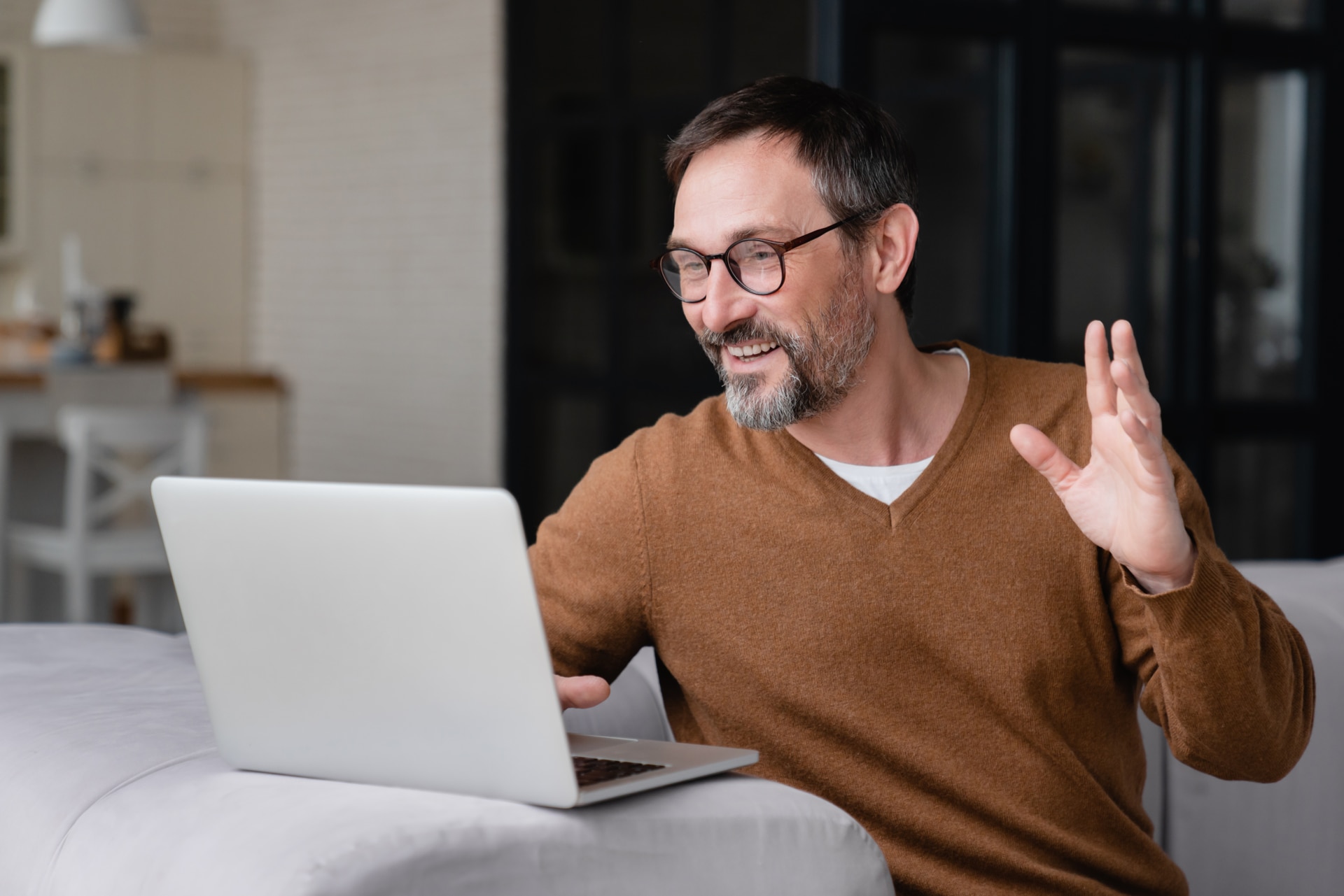 Happy mature middle-aged man businessman freelancer father having online video call conference conversation on laptop remotely with colleagues, friends, children, doctor`s appointment.; Shutterstock ID 2006564918; purchase_order: -; job: -; client: -; other: -