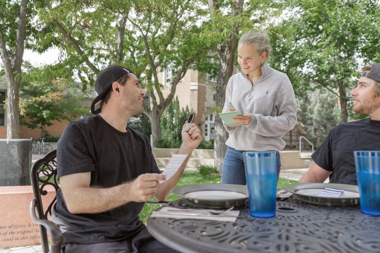 Roger Ambassador sitting at a restaurant table making an order using Roger Select
