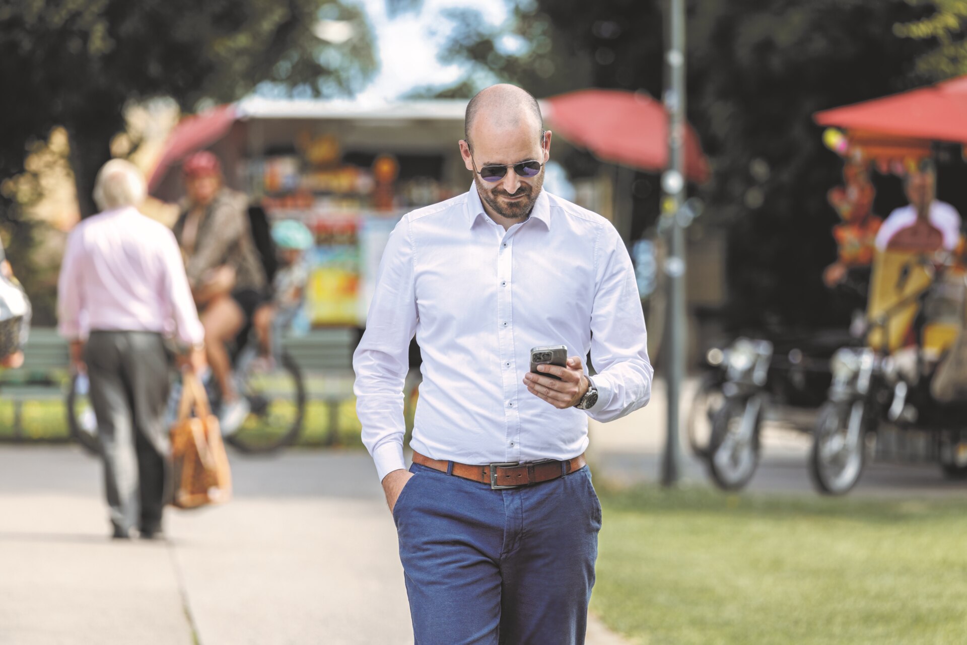 Woman wearing small hearing aid using smartphone