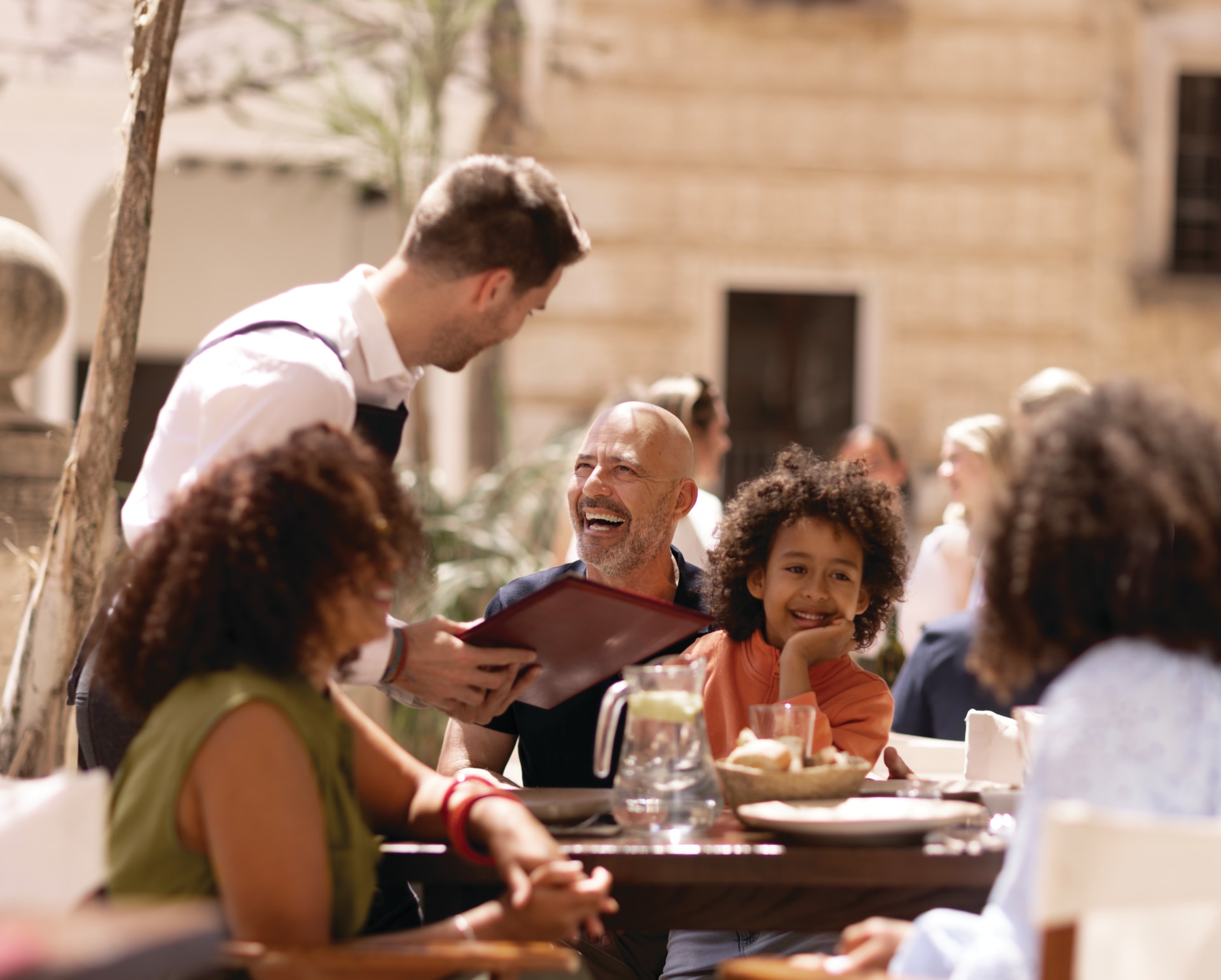 Family at a restaurant talking to the waiter