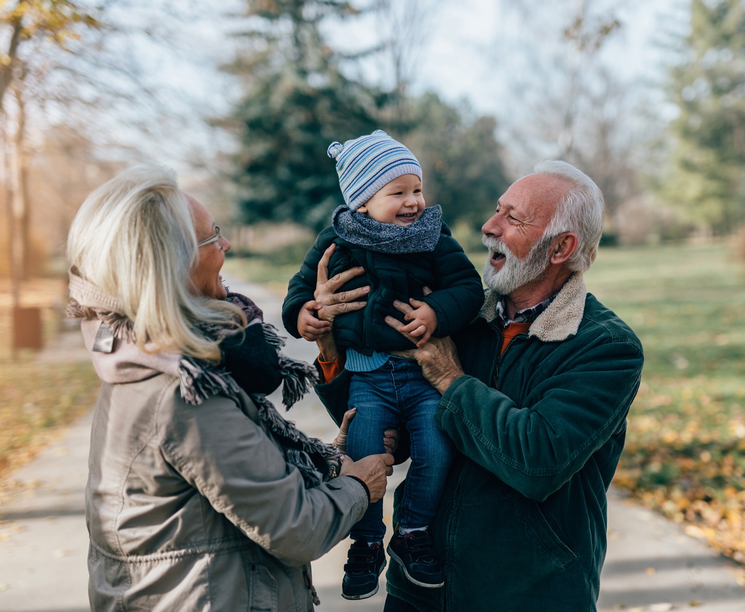 Happy good looking senior couple husband and wife walking and playing with their adorable grandson in public city park; Shutterstock ID 1846904110; purchase_order: -; job: -; client: -; other: -