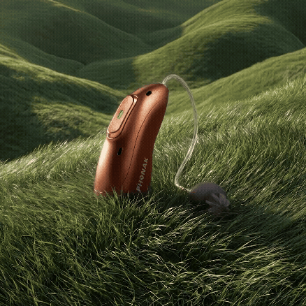 Audeo E-R hearing aid on grass animation