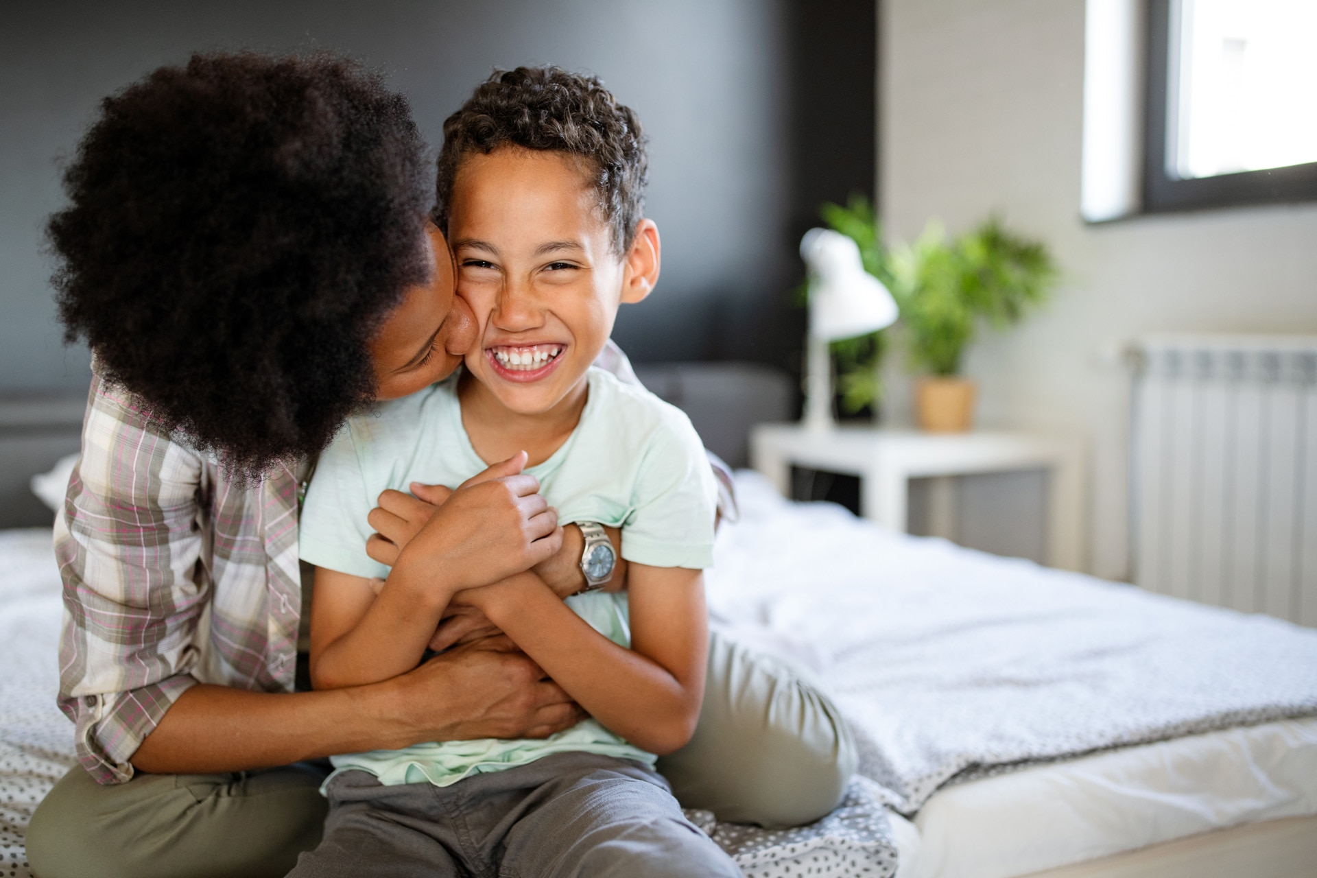 A happy african-american mother having fun with her child