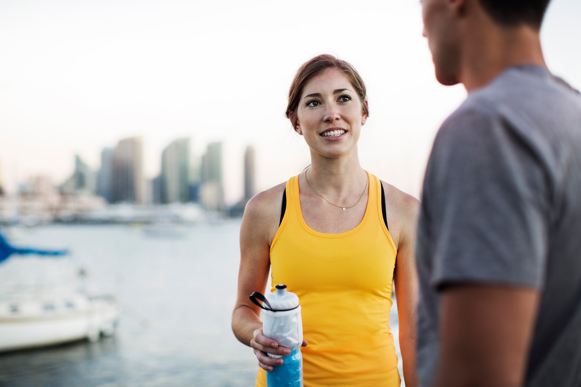 Running couple stopping for water