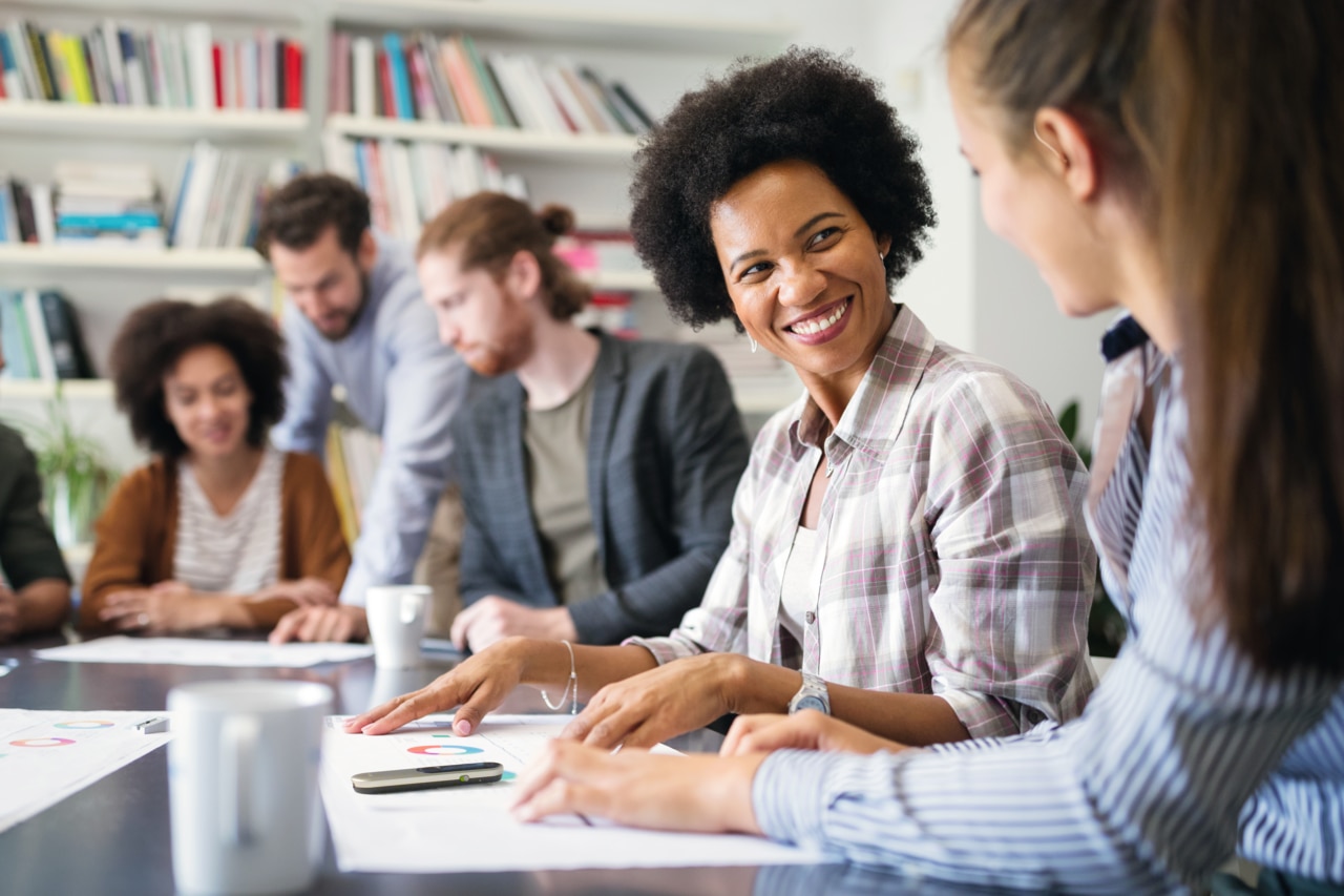 Group of business people collaborating on project in office