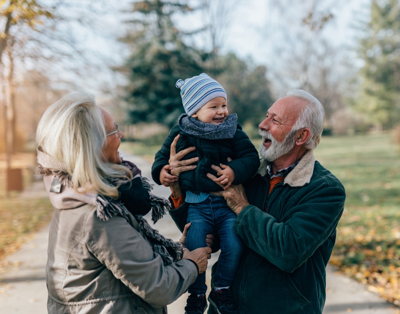 Happy good looking senior couple husband and wife walking and playing with their adorable grandson in public city park; Shutterstock ID 1846904110; purchase_order: -; job: -; client: -; other: -