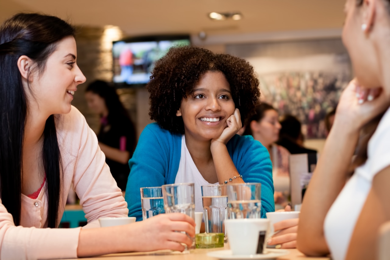 Tenagers girls in cafe chatting in cafe, leisure activities