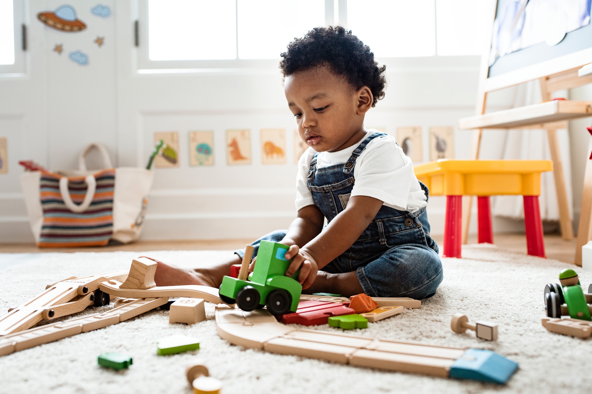 A cute little boy playing a railroad train