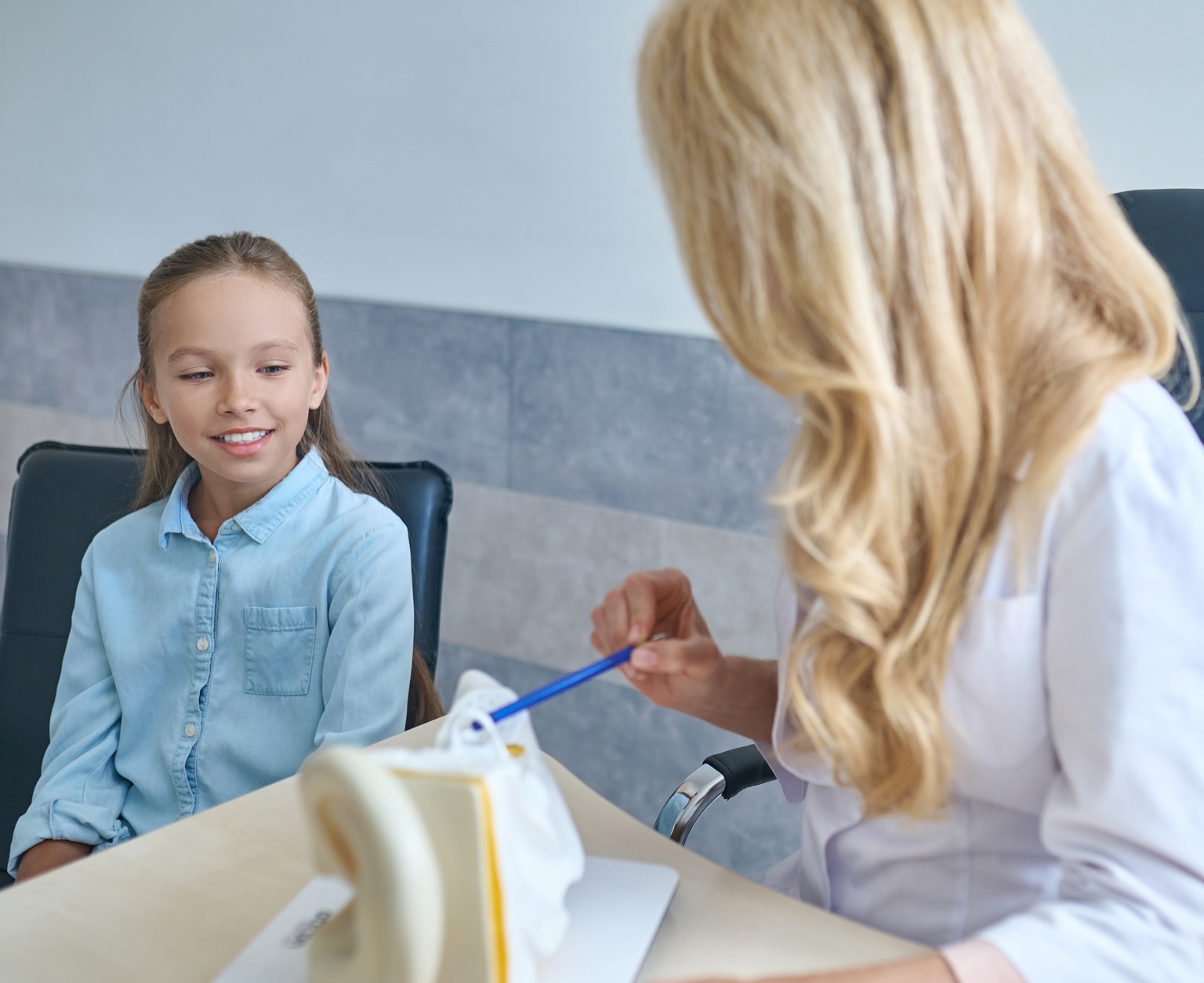 Young female patient being explained the human ear anatomy