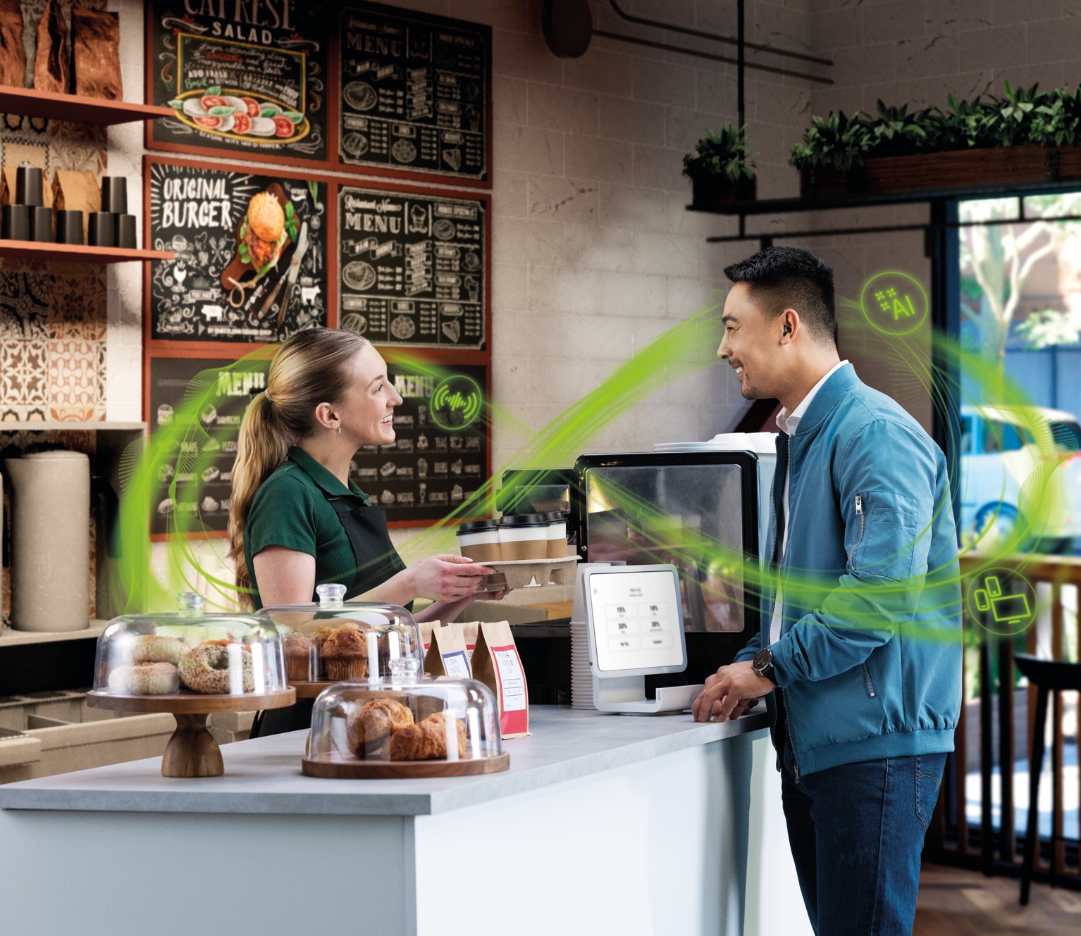  A woman serving a cup of coffee to a man at a cafe table while he pays.