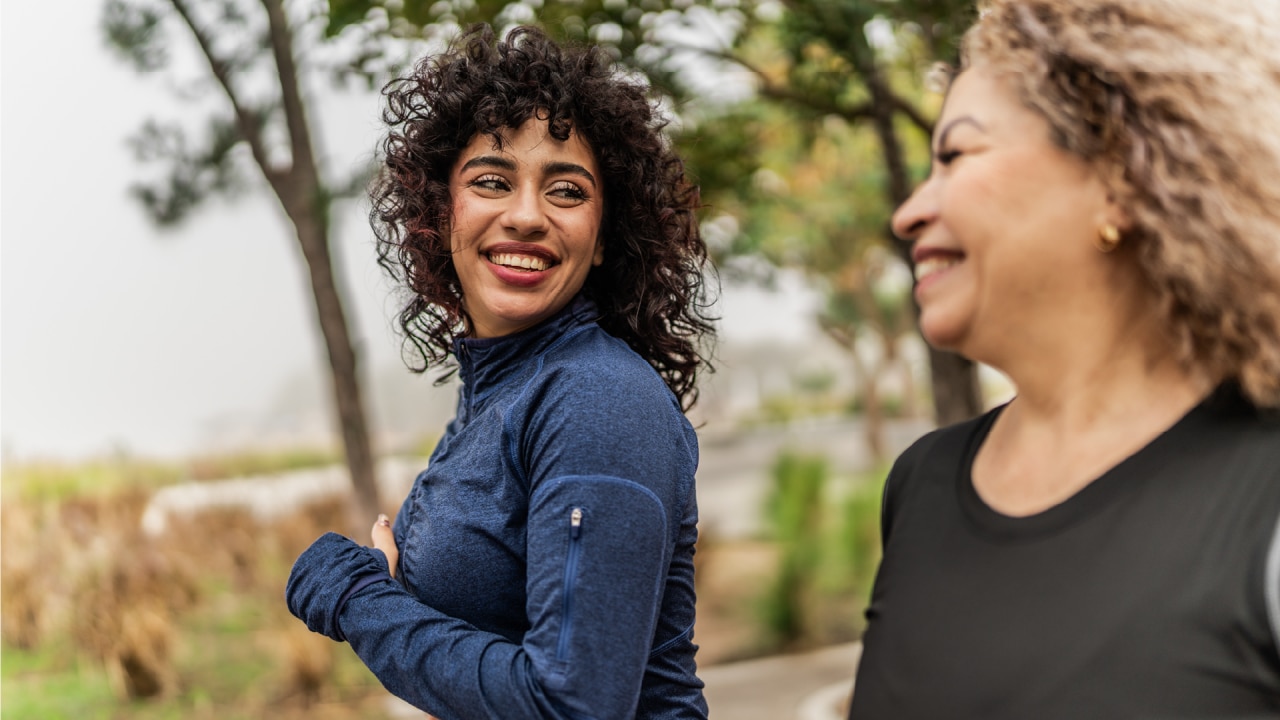 Two women talking and walking