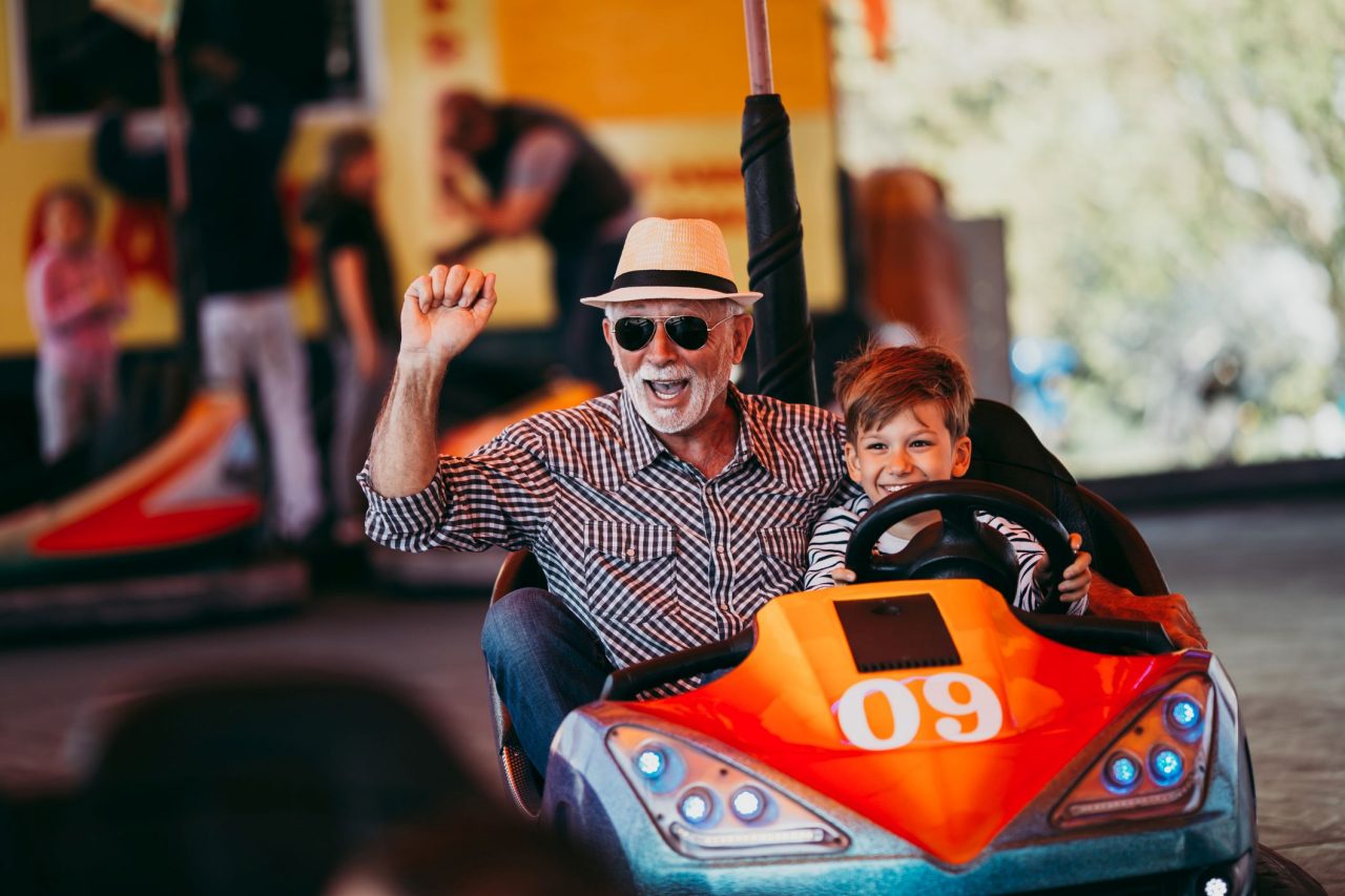 Grandfather and grandson in a bumper car