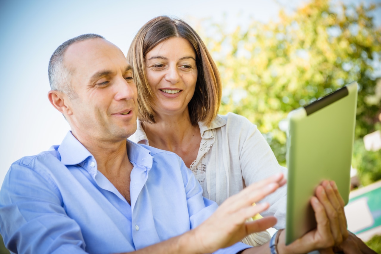 Man and woman looking at tablet together