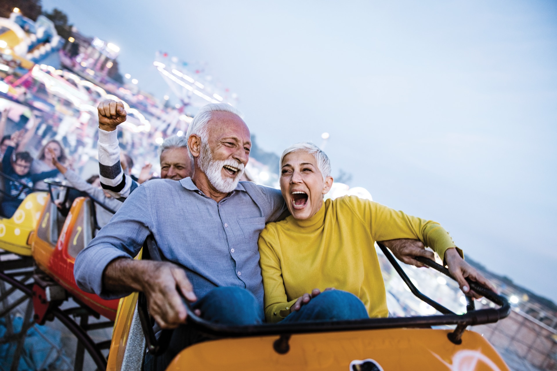 Senior couple enjoying rollercoaster ride