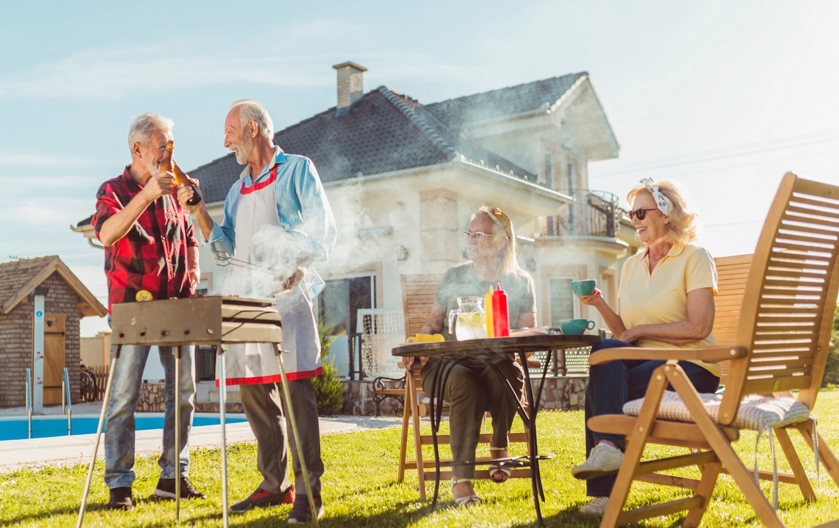 Elderly neighbors having backyard barbecue party