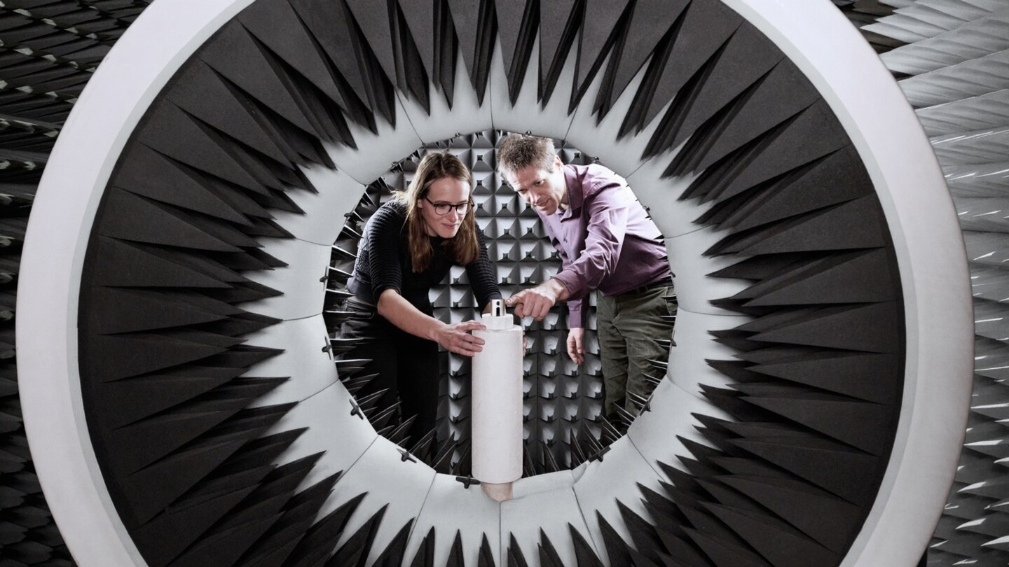 Two scientists setting up sound chamber in Phonak Murten Audiology Research Center 