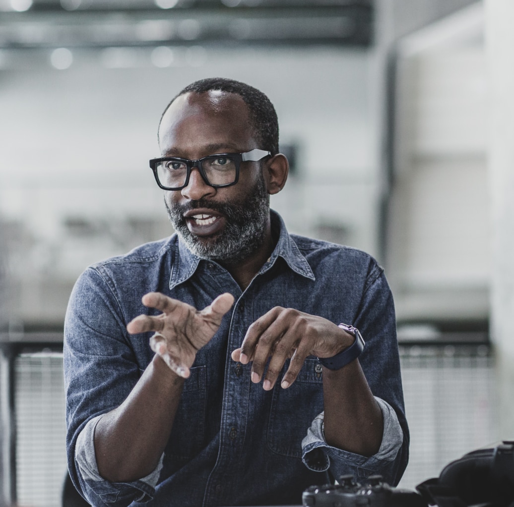 African American male game designer leading a meeting