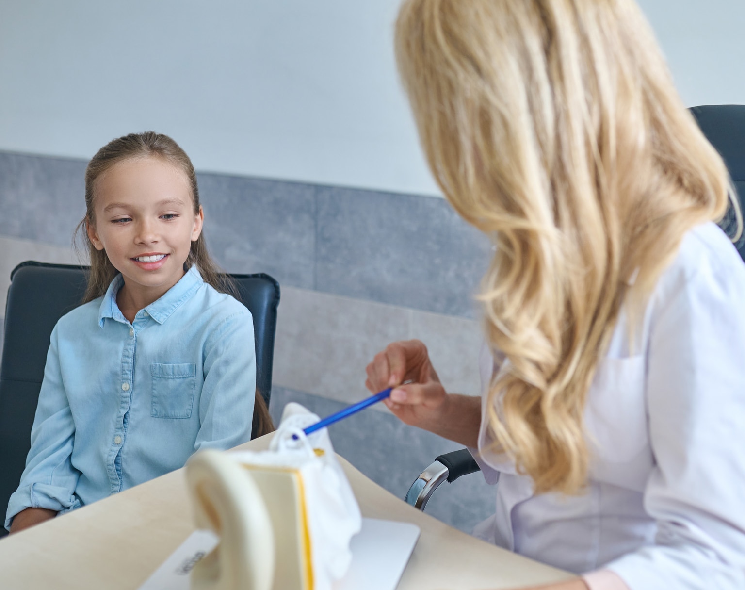 Young female patient being explained the human ear anatomy