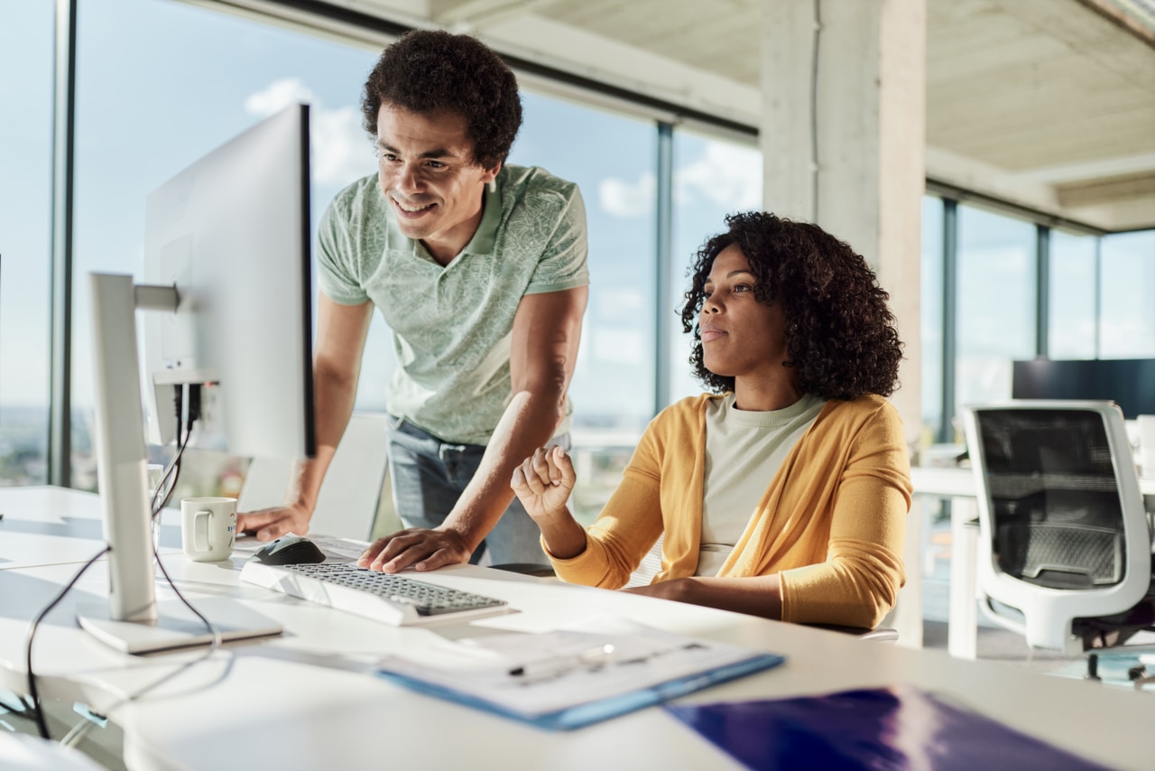 Two people working on a computer