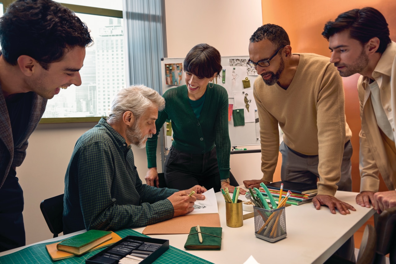 Group huddled around an office desk