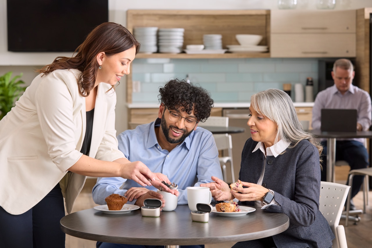 A group of people discussing hearing devices