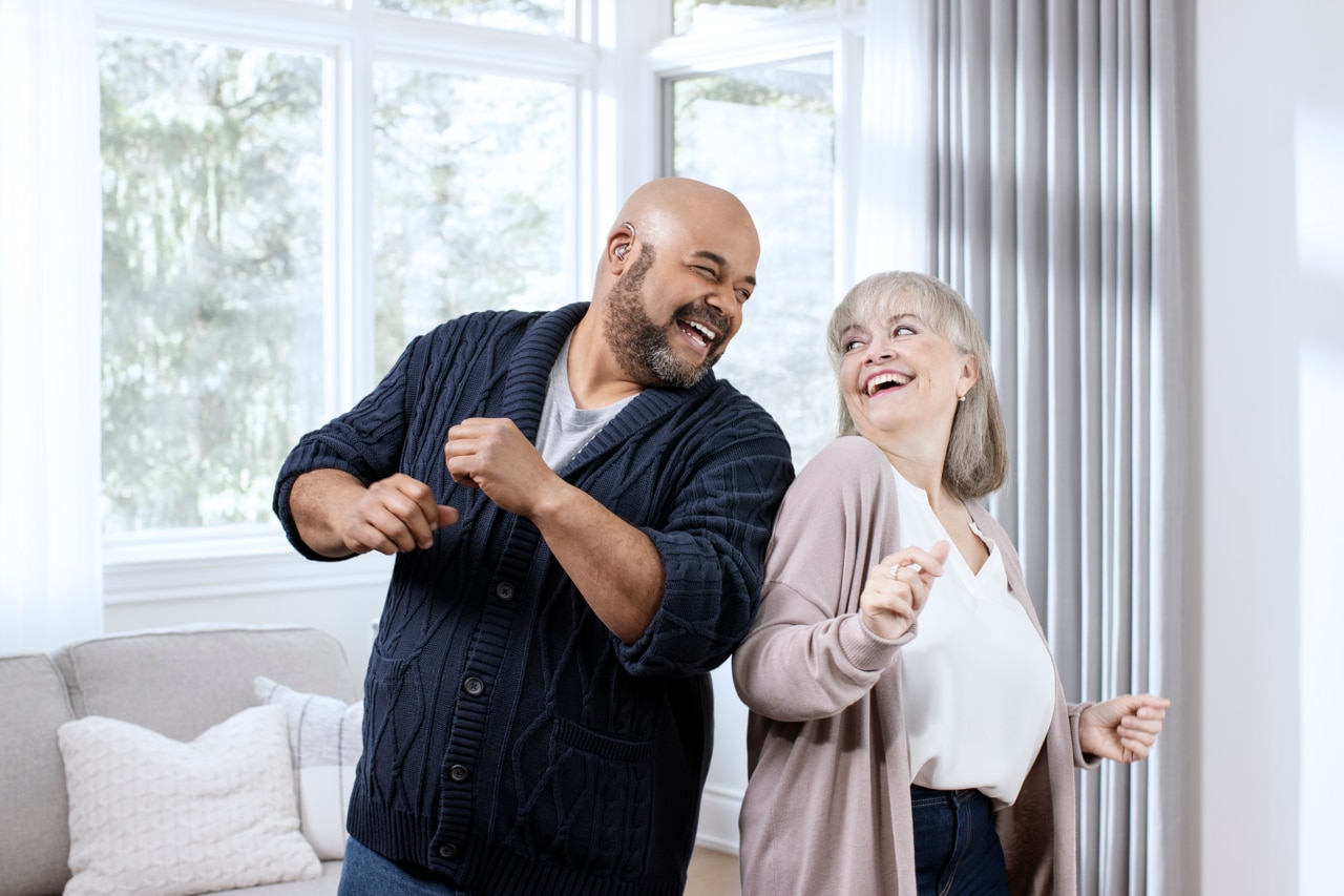 Couple dancing together in living room