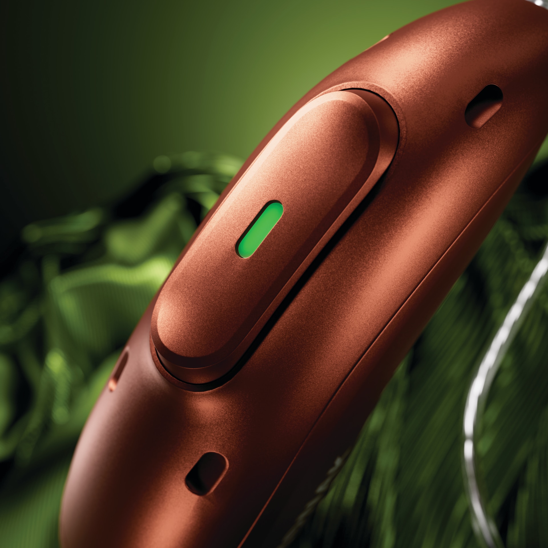 Audeo E-R hearing aid on a green background
