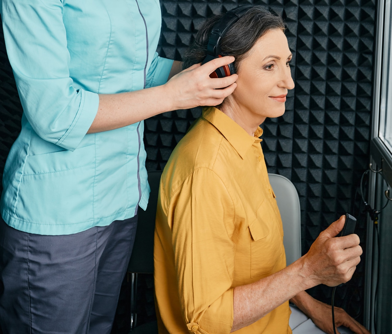 Hearing test to mature woman. Senior woman during hearing test and audiometry at hearing clinic with audiologist. Side view; Shutterstock ID 2009901761; purchase_order: -; job: -; client: -; other: -